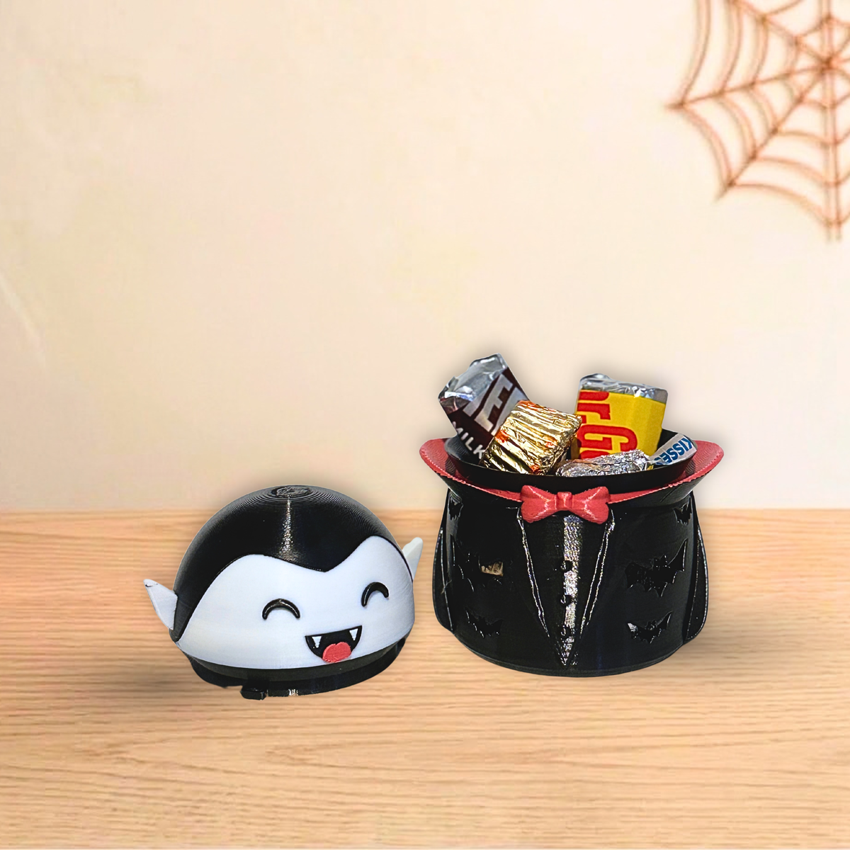Vampire Halloween holder next to an open holder filled with wrapped candy