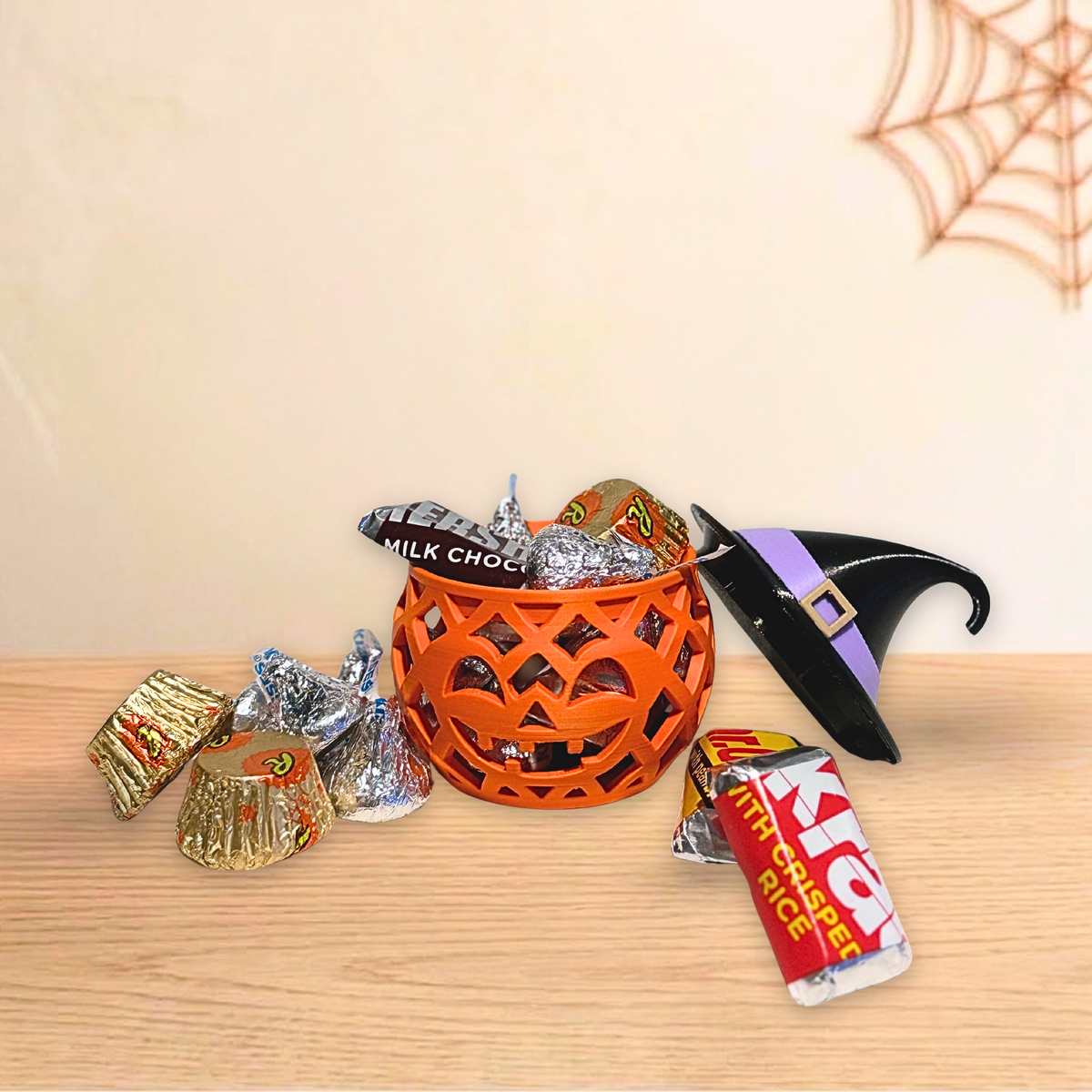 Witch Pumpkin holder with hat lid off and wrapped candy spilling out