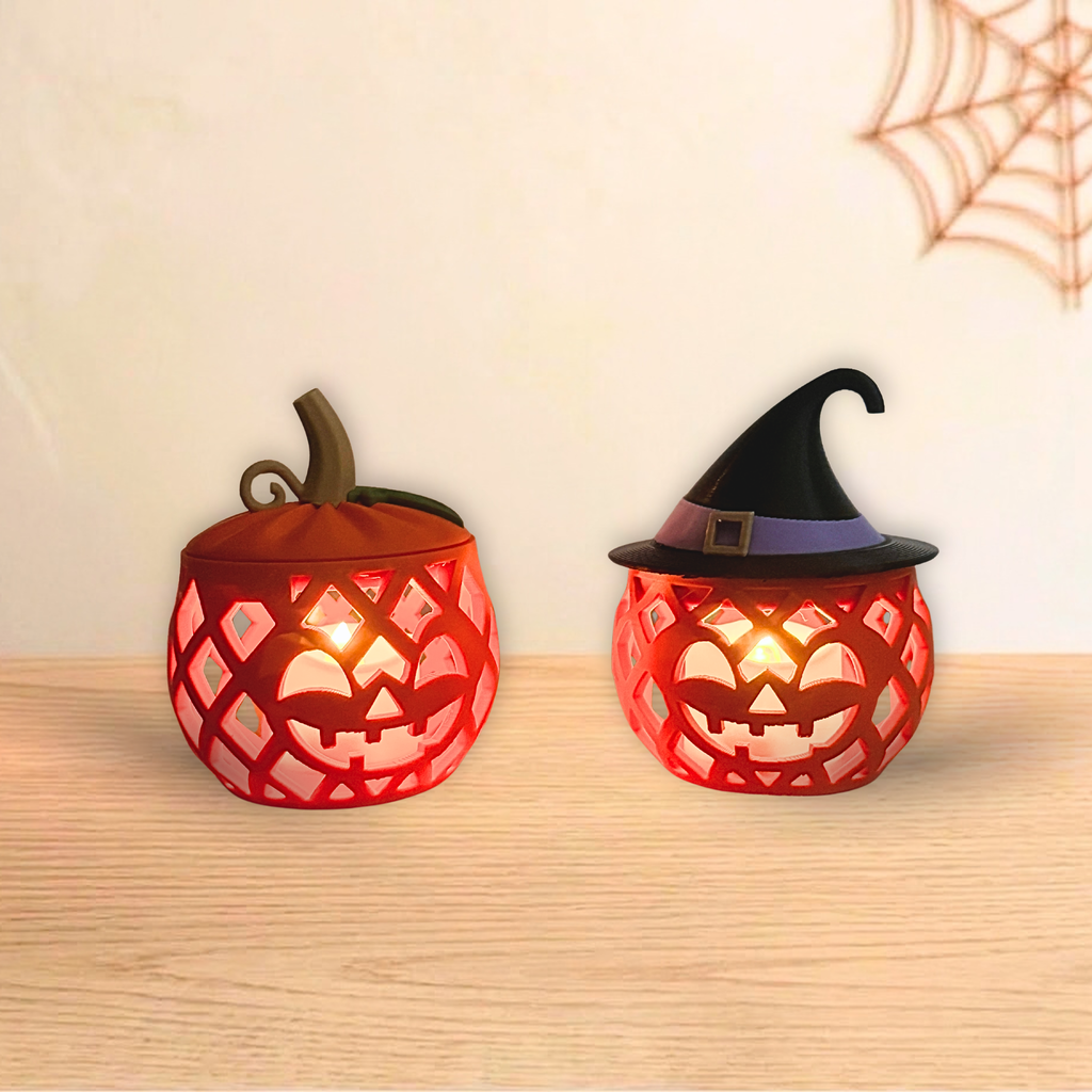 Jack O'Lantern pumpkin and Witch Pumpkin holders glowing with LED tea lights