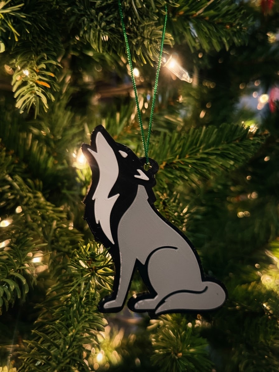 Gray howling wolf ornament on a Christmas tree